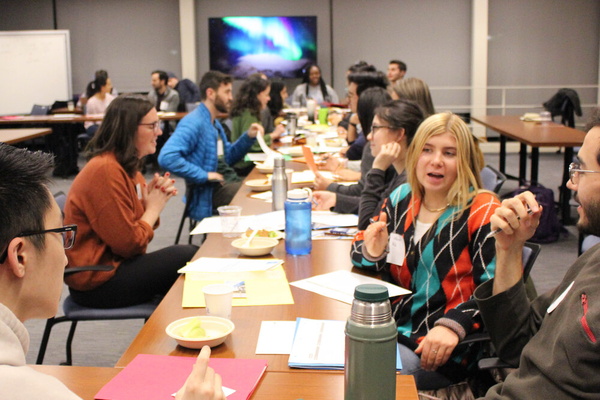 The cohort breaks out into discussion groups.