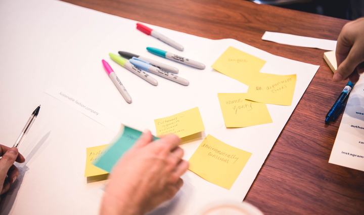 Hand with post-its and Sharpies