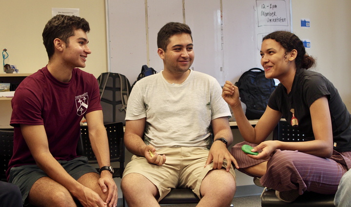 Three students talk in group activity