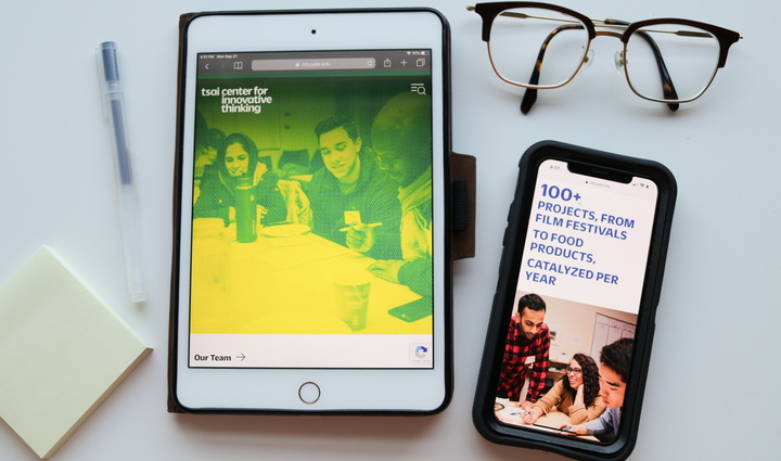 Flatlay image of desk supplies and Tsai CITY imagery on mobile devices