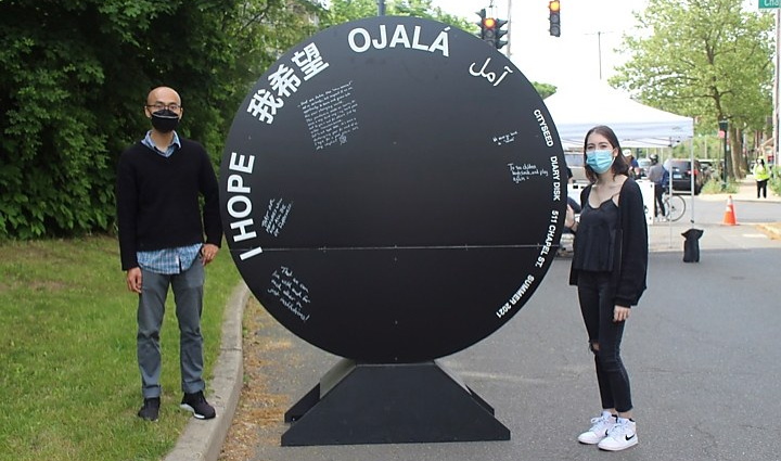 Ye Qin Zhu and Winter Willoughby stand next to Diary Disk installation