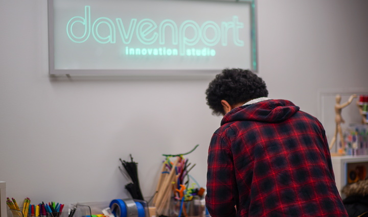 A man focused on his computer screen, typing away with determination.