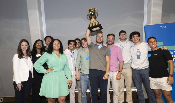 summer fellowship teams holding a trophy