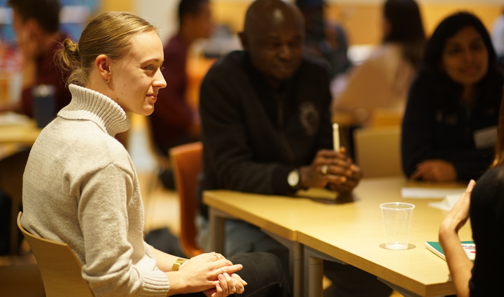 A team of people gathered around a table, collaborating and sharing ideas