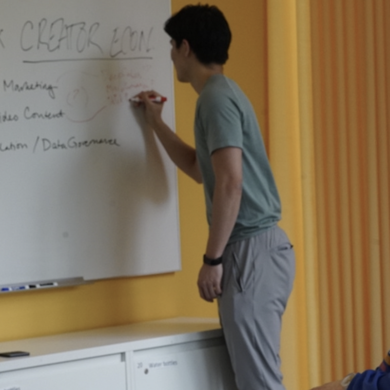 student brainstorming on whiteboard