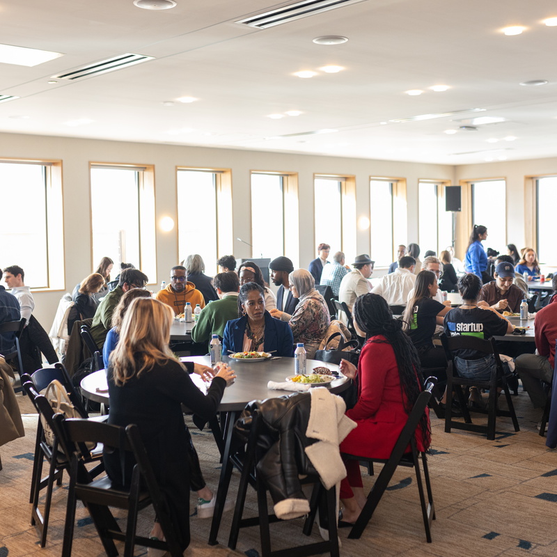 crowded room with people chatting at tables