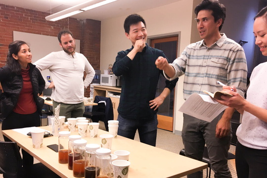 Justin Freiberg and Erwin Li address the cohort before tasting student samples.