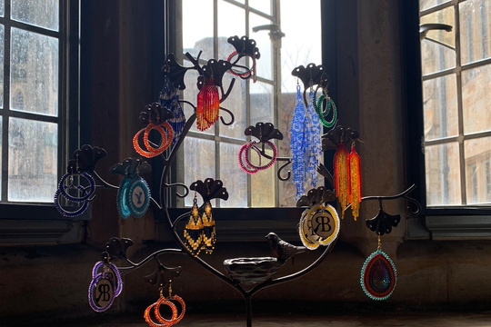 Beaded jewelry pieces displayed on a rack