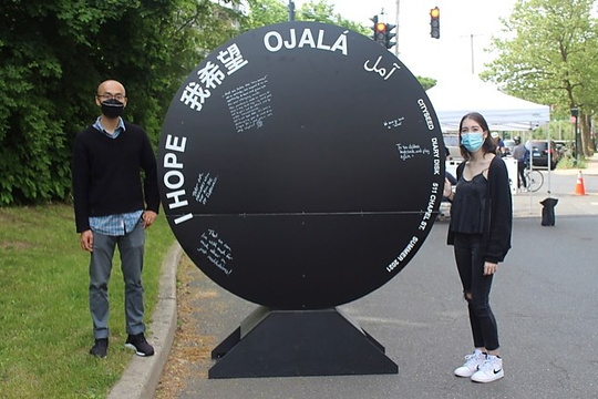 Ye Qin Zhu and Winter Willoughby stand next to Diary Disk installation