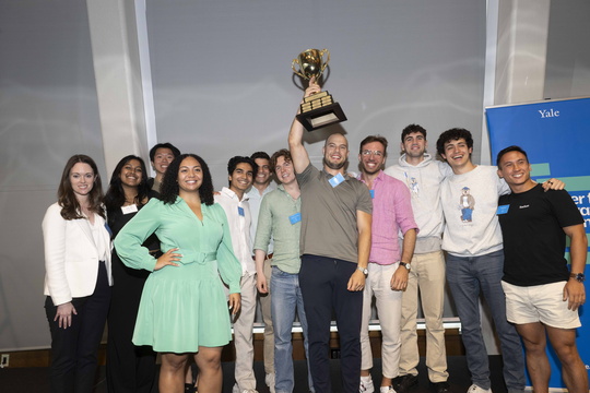 summer fellowship teams holding a trophy 