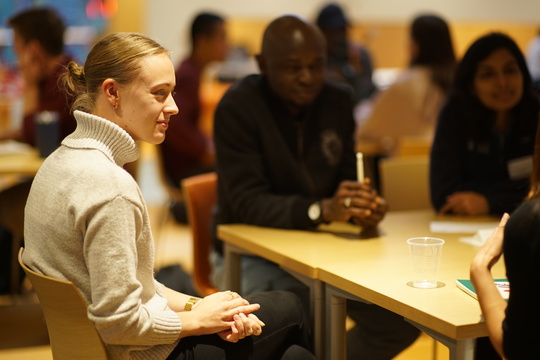 A team of people gathered around a table, collaborating and sharing ideas