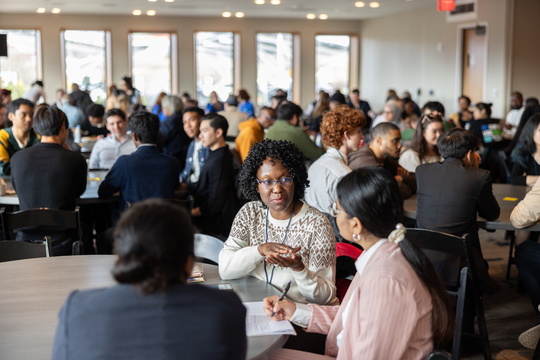 Students at round table having a conversation 